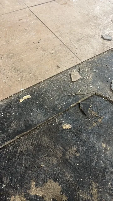 Black bitumen mastic floor removal in a SW10 flat